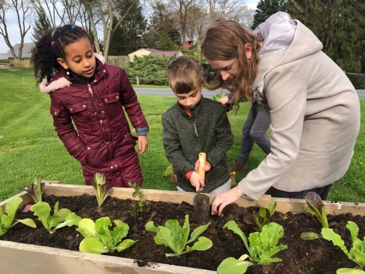 Students with teacher in the learning garden